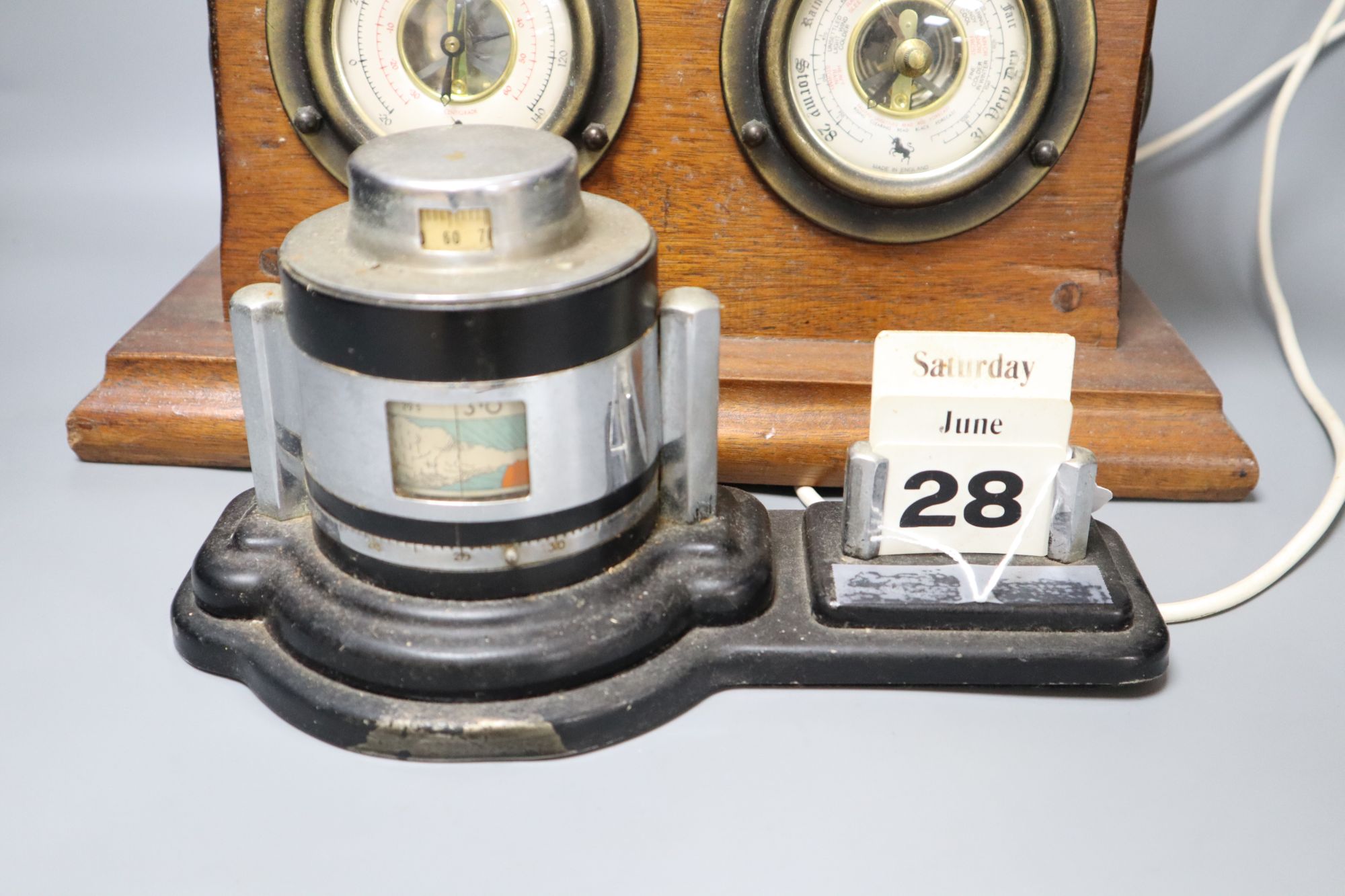 An Art Deco chromium desk calendar/barometer and a mahogany table lamp with thermometer and barometer dials